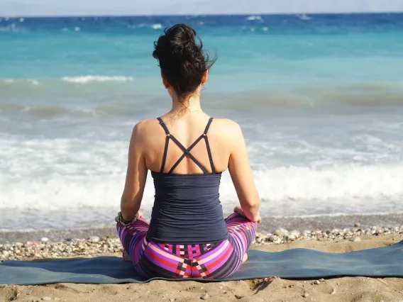 Woman meditating on a beach