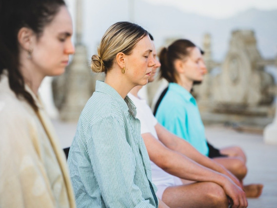 three woman meditating