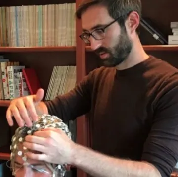 man hooking test subject up to brain scanner